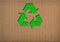 Recycle symbol on cardboard texture
