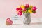 Recycled Heart shape gift box, spring bouquet of pink and yellow tulip flowers in a vase and Lightbox with love you