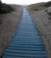 Recycled plastic used as walkway on sand to beach