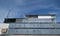 Recycled shipping containers stacked under blue sky