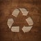 Recycling arrows cycle symbol engraved in wooden board