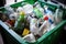 Recycling bin filled with assorted plastic bottles and containers promoting environmental responsibility