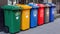 Recycling bins on the sidewalk of a road, city street. Containers with separated garbage. plastic, glass, paper and organic.