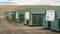 Recycling center - a row of green steel containers with instruction signs at Larimer