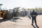 Recycling center worker looking at an unsorted garbage heap