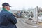 Recycling center worker looking at an unsorted garbage heap, rear view