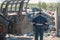 Recycling center worker looking at an unsorted garbage heap, rear view