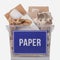 Recycling concept. Cardboard and recyclable paper in a container with the inscription paper isolated