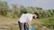 Recycling concept group of diverse volunteers together cleaning a large green beach beside the lake they picking up the