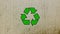 Recycling icon on a brown carton board