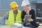 recycling industry workers using tablet outside factory