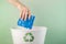 Recycling of personal care products, the hand throws a feminine pad into the trash can