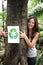 Recycling: woman in the forest with recycle sign