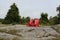 Red Adirondack chairs on a granite hill