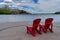 Red adirondack chairs and the Prince of Wales Hotel at Waterton Lakes National Park, in