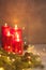Red Advent Burning Christmas candles with sparkling garland