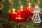 Red advent candles on the old wooden background with christmas light curtain