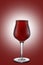 Red ale beer in tulip wineglass isolated on ruby background