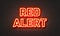 Red alert neon sign on brick wall background.