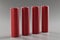 Red alloy batteries stand in a row on a gray background