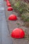 Red anti-parking hemisphere-shaped bollards