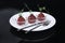 Red appetizing Tartar sauce in three pialas on a plate with a knife and fork, decorated with a stem of sprouted green peas, close-