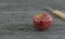 Red apple and blur small knife wood handle on gray wooden surface by 3D rendering