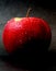 Red apple on dark background