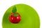 Red apple on a green plate