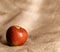 Red apple on hessian cloth