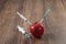 Red apple injecting a needle or syringe and chemical pesticides on a wooden background. Specific pesticide residues in apples,