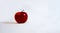 The red Apple lies on a white background