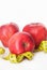 Red Apple with Measure Tape for Loose Weigh, in the Middle of Image, diet and fitness with copy space . Isoalted on