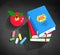 Red apple, pile of books and pieces of chalk