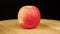 Red Apple rotates 360 degrees on a wooden stand