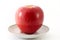 Red apple on a saucer