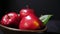 Red apple with stem leaf on bowl. Image fruit