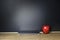 Red apple and tablet on wood table with Blackboard Chalk Board