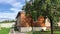 Red apple trees and modern wooden house, backyard, nobody