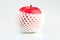 A red apple with water drops on skin in white shockproof foam net wrap on white background with copy space. Healthy fruit