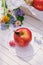 Red apple on white garden table