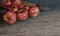 Red apples and blur small knife wood handle on gray wooden surface by 3D rendering