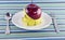Red apples, measuring tape and Flatware in dish on napery.