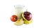 Red apples, measuring tape, glass of milk and tomato on white ba