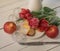 red apples pink flower closeup white background