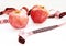 Red apples and pink measuring tape on white background.