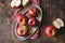 Red apples on plank wooden table