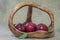 Red apples in wooden basket on natural sacking material