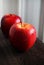 Red apples on a wooden board