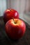 Red apples on a wooden board